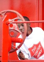Preston Miller, 13, helps out painting the caboose at the Salvation Army Community Center in Una where he is enrolled in their after school program. The United Way hosted a "Week of Caring". There were lots of community leaders on hand to paint the old caboose that is part of the playground at the center.    (ASHLIE NEWS)