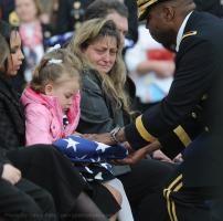The funeral of Sgt. Jeremiah Wittman. was held Saturday, February 27, 2010 at Buck Creek Baptist Church in Chesnee. Here Wittman's widow Karyn, and 3-year-old daughter Miah are given the flag from Jeremiah's coffin.gpshj 02/27/2010