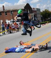 Here Quinn Semling with ProTownn BMX  jumps over volunteers holding his bike during the 6th annual A Taste of Woodruff Fall Festival  on Main Street in Woodruff, Saturday, Sept., 13, 2008.
