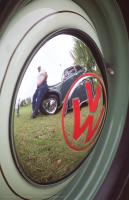 Malcome Rupe's reflection in one of his VW hub caps.