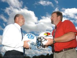 Polk County High School head coach Bruce Ollis and good friend John Cann butt helments in fun as game time approaches Friday night.(SPORTS JASON)