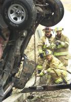 Westview Fairforest Firemen keep a hose pointed at ththis Jeep Wrangler that was leaking gas while a wrecker pulled it from the creek after it weent over a bridge on Old Georgia Road.